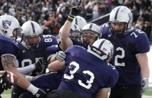 <p>The Tommies celebrate after running back Colin Tobin scores the first points of the game. In the second quarter Bethel answers to bring the game to 7-6 at the half. (John Kruger/TommieMedia)</p>