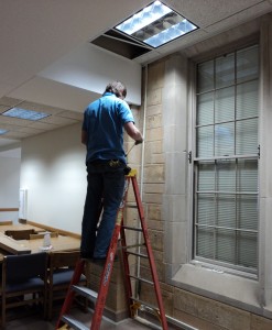 110203_Library_Outlets.006 A physical plant employee installs new electrical outlets in the O'Shaugnessey-Frey Library. (Tom Graves/TommieMedia)