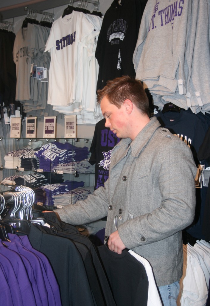 Senior Micah Anderson shops for St. Thomas clothes for family and friends. (Ariel Kendall/TommieMedia)