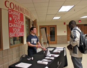 <p>Mike Orth, Undergraduate Student Government sophomore class president, talks to a student about fire safety. (Theresa Malloy/TommieMedia)</p>