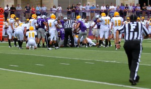 110903_FOOTBALL_005 The Tommies and Green Knights jump on the loose ball. Each team fumbled the ball once during the game. (Theresa Malloy/TommieMedia).