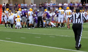 The Tommies and Green Knights jump on the loose ball. Each team fumbled the ball once during the game. (Theresa Malloy/TommieMedia). 