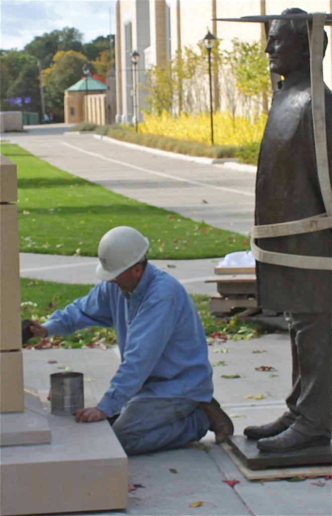 <p>This is a picture of Marvin Eiynck, a masonry worker for OPUS construction company, preparing to install the statue of archbishop John Ireland. (Patrick Roche/TommieMedia)</p>
