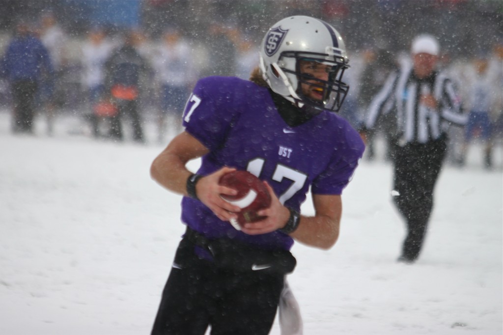 <p>Quarterback Dakota Tracy scrambles for short yardage in the snow. (Rita Kovtun/TommieMedia)</p> 