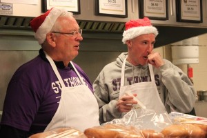 Athletic Director Steve Fritz and head basketball coach John Tauer prepare meals at The Grill. (Tom Graves/TommieMedia)