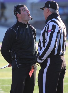 Coach Glenn Caruso has a conversation with a referee during the semifinal playoff game against Wisconsin-Whitewater. (Ryan Shaver/TommieMedia)