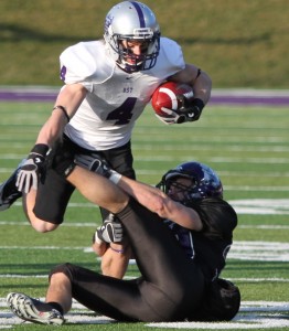<p>Senior Fritz Waldvogel tries to break a tackle in the NCAA semifinal game against Wisconsin-Whitewater. (Ryan Shaver/TommieMedia)</p>