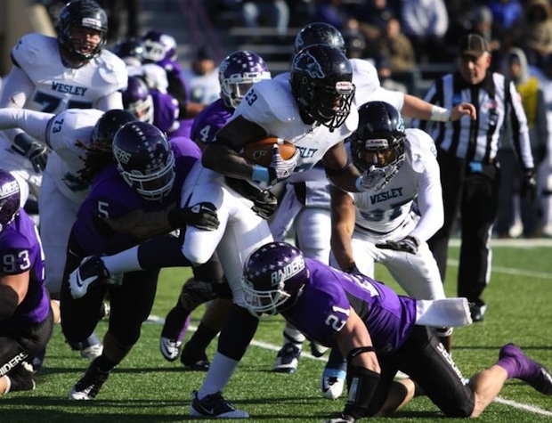 111210_mtunion <p>Mount Union's Arthur Smith (5) and Mark Wood (21) converge on Wesley running back Askia Jahad in an NCAA Division III semifinal, Saturday in Alliance, Ohio. Mount Union's defense forced six turnovers to win 28-21. </p>