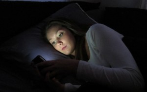 Junior Megan Kelly stays up late to check her text messages. (Anna Tu/TommieMedia)