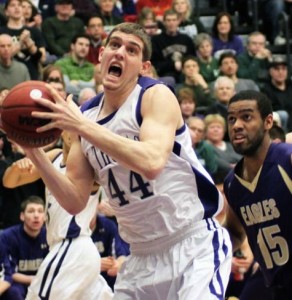 Senior Tommy Hannon puts an offensive rebound back up for a basket in a 2011 game. (Ryan Shaver/TommieMedia)</p>