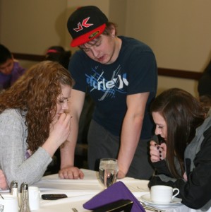Breakfast Club participants freshmen Caity Kubicek, Ben Van Ort and Aileen Conway work together to solve a cryptogram puzzle. The three week program started Monday, Feb. 27, and will conclude Friday, March 16. (Anastasia Straley/TommieMedia) 