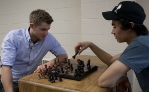 Chess club president freshman Devon Quist and vice president freshman David Zosel play a game of chess. They used a YouTube video to promote the universality of chess. (Laura Landvik/TommieMedia)