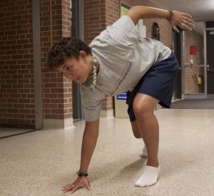 Junior Raenel Horton does lunges to prepare for the strenuous, uphill portion of the Tough Mudder obstacle course on May 19 and 20. (Laura Landvik/TommieMedia)