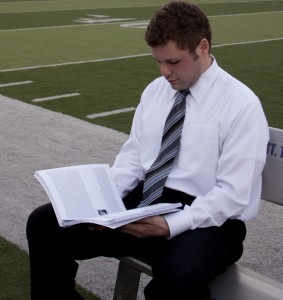 Shawn Zobel looks at a player profile in his "2012 Draft Preview." Zobel completed the book, which includes analysis of 255 college football players. (Heidi Enninga/TommieMedia) 