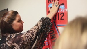 <p>Sophomore Claire Dittmann posts a Kony 2012 flyer Friday night in the John Roach Center during the "Kony 2012 Cover the Night" event. (Katherine Curtis/TommieMedia)</p> 