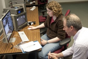 120425_FILM_MINOR Junior Colleen Schreier edits video with Professor Tim Scully in the Avid lab during his COJO 360 Videography: Television Production in the Field course that may count toward the film minor. (Laura Landvik/TommieMedia)