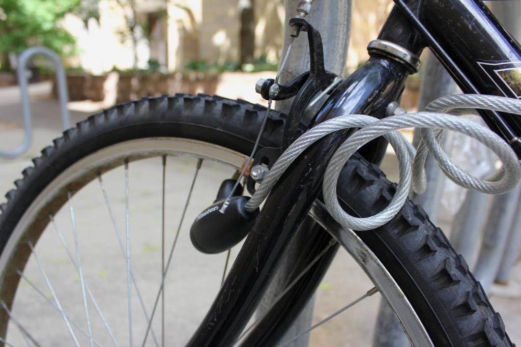 120528_bike_theft_Final_picture <p>A wire lock secures a bike on campus outside of the O'Shaughnessy Educational Center. According to Public Safety, in May 2012 alone, 15 bikes were stolen on campus. (Hannah Anderson/TommieMedia)</p>
