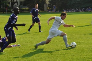 120904_Soccer_2 Junior defensive mid fielder Kit Weaver zooms across the field to shoot. St. Thomas outshot Northwestern 25-1 in shots on goal. (Ali Stinson/TommieMedia)