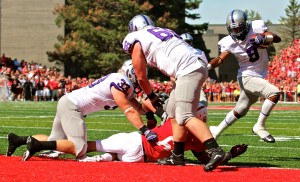 <p>Sophomore running back Ryan Toney receives help from Tommie blockers as he rushes in for a touchdown. St. Thomas went 2-for-2 in the red-zone during the first half. (Rosie Murphy/TommieMedia)</p> 