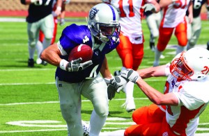 12092008_Football St. Thomas senior wide receiver Fritz Waldvogel breaks a tackle against a Macalester player during his first football season. (TommieMedia)