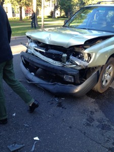 <p>A tan SUV sits demolished on Summit Avenue just before the St. Thomas bus stop pedestrian crosswalk.  The car was hooked onto a large white van after the two collided Wednesday late afternoon. (Hannah Anderson/TommieMedia)</p> 