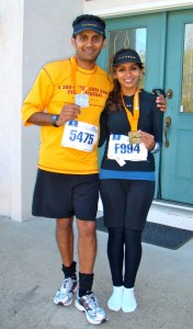 <p>Geena Maharaj poses with her father in front of her family's home after finishing the Twin Cities Marathon in 2010. It was her first marathon and her father's third. (Geena Maharaj/TommieMedia)</p> 