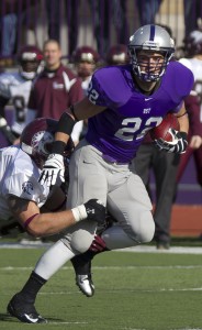 Sophomore running back Jack Kaiser fights off an Augsburg College defender during the St. Thomas football team's 2012 season. The Tommies have won their last five games against the Auggies. (Meg Thompson/TommieMedia) 