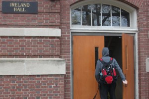 <p>An Ireland Hall resident swipes himself into the building. Aaron Macke, director of Residence Life, described the dorms as "porous" because of the various entrances. (Baihly Warfield/TommieMedia)</p>