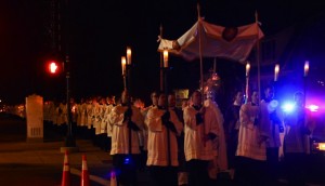 <p>Police cars block traffic as the Holy Eucharistic procession fills the streets Friday night. More than 350 people participated in the procession. (Caroline Rode/TommieMedia)</p>