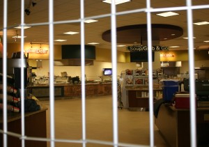 <p>The metal gates are pulled down in front of closed T's on Thursday night. University administrators addressed student questions about hours for campus eateries, the presidential search, and internet speeds at a forum sponsored by the Undergraduate Student Government. (Heidi Enninga/TommieMedia)</p>