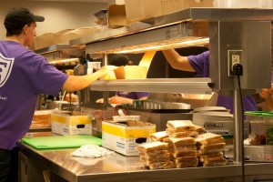 <p>Scooter's workers serve "Lavin Burgers" to give away for free. The Alumni Association provided the peanut butter and jelly sandwiches as part of Father Lavin Day to celebrate what would have been Lavin's 94th birthday. (Geena Maharaj/TommieMedia)</p>