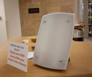 <p>A SAD lamp sits on the front desk in the O'Shaughnessy-Frey Library. While the library used to have the SAD lamp sitting at a table open for students to use, they recently implemented a checkout process to create a more flexible and mobile system for users. (Gabrielle Martinson/TommieMedia)</p>