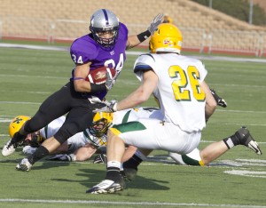 Running back Brenton Braddock weaves his way past St. Norbert defenders. Braddock had 62 rushing yards in the first half and three touchdowns (Meg Thompson/TommieMedia)