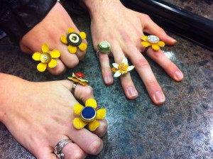 <p>Junior Lindsey Landgraf and sophomores Jesse Stone and Mariann Kukielka sport their own creations. Every piece of fruit jewelry is hand-crafted and made from lemons and limes. (Stephanie Dodd/TommieMedia)</p>