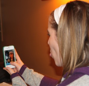 121128_Snapchat <p>Senior Hallie Lundell uses Snapchat to send a funny face photo to her friend. Lundell will not find her photo on Facebook later because the app permanently deletes the photo after it's viewed. (Laura Landvik/TommieMedia)</p>