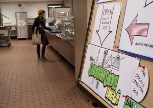 <p>A student orders lunch at the Binz Refectory on South Campus. The Southside Deli, opening spring 2013, will wrap around the back of the main entrée line. (Laura Landvik/TommieMedia)</p>