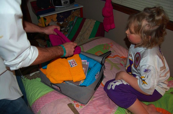 Sophomore Brian Keller shows cancer patient Ashley Boesel a variety of Love Your Melon hats. Boesel is in remission from a treatable type of leukemia, and the company donated 20 hats to her family. (Photo courtesy of Love Your Melon)