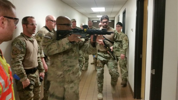 SWAT Team officer Ramar Davis, 39, takes point as he and his partner respond to the sound of gunshots fired somewhere in the BEC. Officers used simulation rounds instead of blanks to avoid setting off the smoke detector. (Simeon Lancaster/TommieMedia)