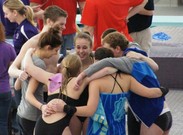 <p>Diver Casey Nightingale and her teammates embrace in celebration during Saturday's conference invitational. (Photo courtesy of Nigel Nightingale)</p> 