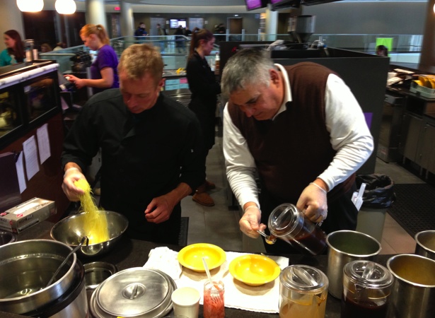 <p>Loft Supervisor Bruce Person and Ariake Representative Gary Ramsy prepare a bowl of ramen noodles. Person said the noodle bar was added to the Loft to drive students to the third floor of the Anderson Student Center. (Zachary Zumbusch/TommieMedia)</p> 