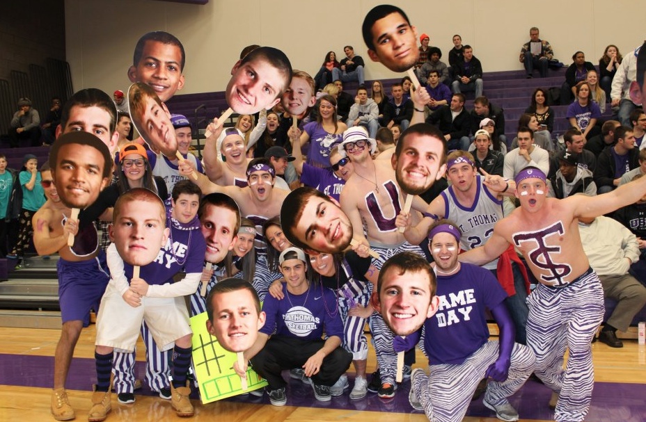 Big Heads are a new phenomena at St. Thomas men's basketball games. The posters, which began on Senior Night, have increased fan involvement in games and may spread to a wide variety of sports. (Courtesy of Sue Hannon)