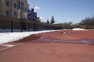 Snow piles remain lingering along the long jump runway at the south end of O'Shaughnessy Stadium. Spring sports teams, including the softball and baseball teams, may face several postponed games due to snow remaining on various MIAC athletic fields. (Jacob Sevening/TommieMedia)