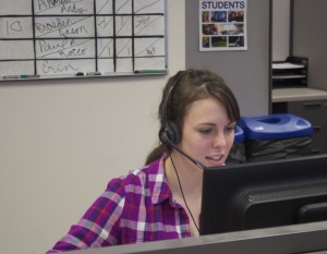 Junior Erin Whitacre asks an alumnus to donate money to the university. Callers have goals each night, and the number of calls students make depends their assigned segment and if alumni answer their phones. (Bjorn Saterbak/TommieMedia)