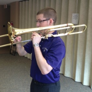 Junior St. John Vianney Seminary student Christian DeCarlo practices an instrument (trombone?) in hopes of achieving his goal for St. Thomas to get its first marching band. DeCarlo spent his spring semester presenting the idea to university officials. (Zach Zumbusch/TommieMedia)