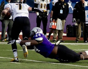 Defensive lineman Ayo Idowu tackles a Wisconsin-Oshkosh offensive player in the national semifinal game last year. Idowu finished the game with five tackles and a touchdown. (Rosie Murphy/TommieMedia)