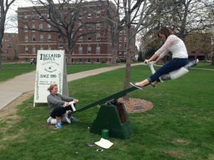 Freshman Anne Marie Keating (left) and Ashely Zweber teeter-totter in support of the Tubman Family Alliance. The freshman took over the teeter-totter after they found it sitting empty. (Zach Zumbusch/TommieMedia)