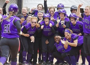 Teammates huddle around home plate as Emily Gregory rounds the bases after her home run against Washington University-St. Louis in the NCAA tournament. (Andrew Stafford/TommieMedia)