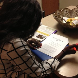 Junior Nyajal Dup studies for her Business Ethics class at her kitchen table. Dup is one of the many female students on campus who is passionate about business. (Kayla Bengtson/TommieMedia) 