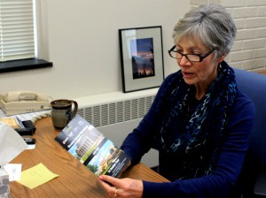 Diane Crist, Director of the Career Development Center, looks at career development materials. Crist said the Career Development Center encourages students to consider salary when searching for jobs. (Grace Pastoor/TommieMedia) 