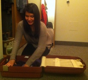 Freshman Vietnamese international student Nu Mai packs her suitcase for Texas. Mai said she will celebrate her first Thanksgiving with her aunt and uncle. (Stephanie Dodd/TommieMedia)